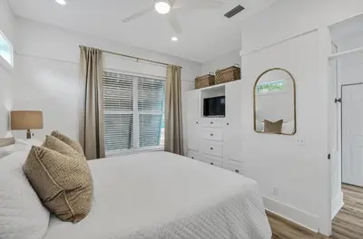 a white bedroom with a bed and a mirror at Available for Season! Seagrove Harbor 30A - Private Pool in Seagrove Beach