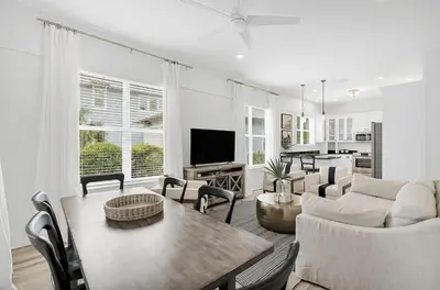 a living room with a table and a couch at Available for Season! Seagrove Harbor 30A - Private Pool in Seagrove Beach