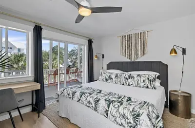 a bedroom with a bed and a desk and windows at Available for Season! Sand Castle at Seagrove Beach in Santa Rosa Beach