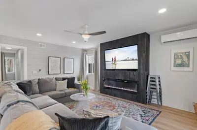 a living room with a couch and a flat screen tv at Available for Season! Sand Castle at Seagrove Beach in Santa Rosa Beach
