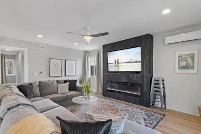 a living room with a couch and a flat screen tv at Available for Season! Sand Castle at Seagrove Beach in Santa Rosa Beach