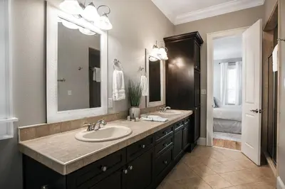 a bathroom with two sinks and a large mirror at You've Hit The Vacay Jackpot with This Sure Winner! in Rosemary Beach