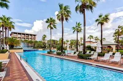 a swimming pool at a resort with palm trees at You've Hit The Vacay Jackpot with This Sure Winner! in Rosemary Beach