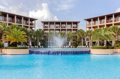 a swimming pool with a fountain in front of two buildings at You've Hit The Vacay Jackpot with This Sure Winner! in Rosemary Beach