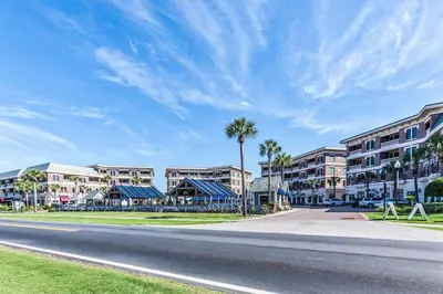 a street in front of a building with palm trees at You've Hit The Vacay Jackpot with This Sure Winner! in Rosemary Beach