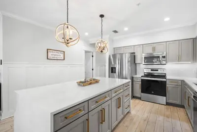 a kitchen with white cabinets and a white counter top at Available for Season. Gone Coastal at Seacrest in Inlet Beach