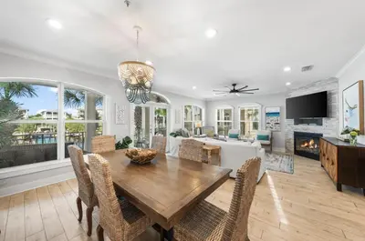 a dining room with a table and chairs and a fireplace at Available for Season. Gone Coastal at Seacrest in Inlet Beach