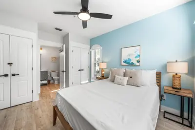 a bedroom with a large white bed and blue walls at Available for Season. Gone Coastal at Seacrest in Inlet Beach