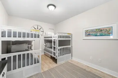 a white room with two bunk beds in it at Available for Season. Gone Coastal at Seacrest in Inlet Beach