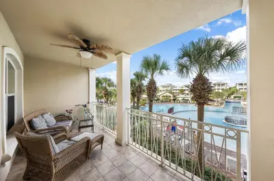 a balcony with a view of a pool at Available for Season. Gone Coastal at Seacrest in Inlet Beach
