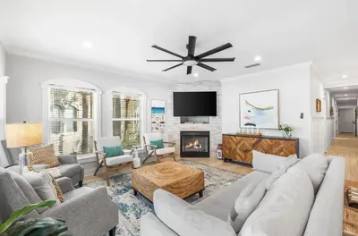 a living room with a couch and a fireplace at Available for Season. Gone Coastal at Seacrest in Inlet Beach