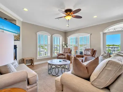 a living room with two couches and a ceiling fan at Penthouse Paradise Condo at Seacrest in Rosemary Beach