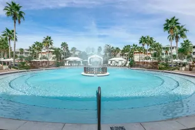 a large pool at a resort with palm trees at Penthouse Paradise Condo at Seacrest in Rosemary Beach