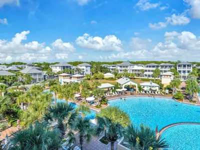 an aerial view of a resort with a pool and palm trees at Penthouse Paradise Condo at Seacrest in Rosemary Beach