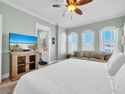 a bedroom with a bed and a flat screen tv at Penthouse Paradise Condo at Seacrest in Rosemary Beach