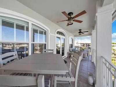 a dining room with a table and a ceiling fan at Penthouse Paradise Condo at Seacrest in Rosemary Beach