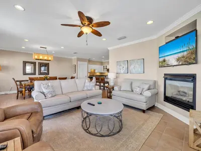 a living room with a couch and a fireplace at Penthouse Paradise Condo at Seacrest in Rosemary Beach