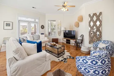 a living room with a white couch and a tv at Seacrest Beach Gem with Shared Pool and Game Room in Seacrest