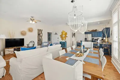 a living room with a table and white furniture at Seacrest Beach Gem with Shared Pool and Game Room in Seacrest