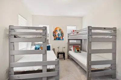 two bunk beds in a small room with a bedroom at Seacrest Beach Gem with Shared Pool and Game Room in Seacrest