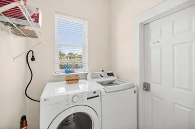 a white washing machine in a laundry room with a window at Seacrest Beach Gem with Shared Pool and Game Room in Seacrest