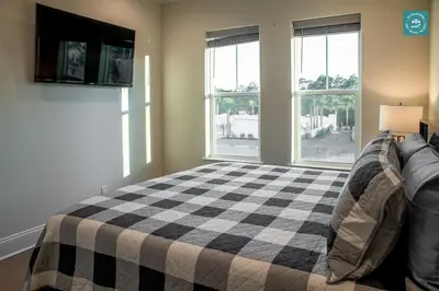 a bedroom with a bed with a checkered blanket at R3 at Inlet Beach with Pool Access and EV Connector - Walk to Beach in Inlet Beach