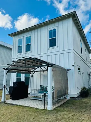 a house with a pergola on a deck at R3 at Inlet Beach with Pool Access and EV Connector - Walk to Beach in Inlet Beach
