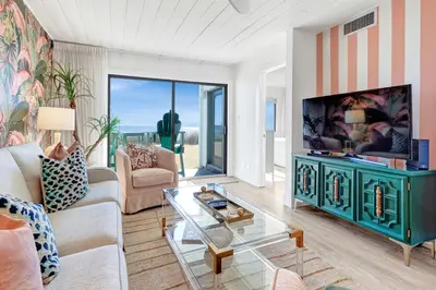 a living room with a couch and a tv at Gulf Front, Seagrove Beach, Sleeps 6, 1st floor, private beach access!! in Seagrove Beach