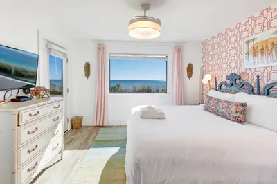 a bedroom with a bed and a tv and a window at Gulf Front, Seagrove Beach, Sleeps 6, 1st floor, private beach access!! in Seagrove Beach