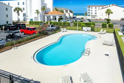 a swimming pool at a resort with a parking lot at Gulf Front, Seagrove Beach, Sleeps 6, 1st floor, private beach access!! in Seagrove Beach