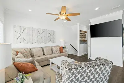 a living room with a couch and a ceiling fan at Beach House - Riviera Retreat by Panhandle Getaways in Panama City Beach