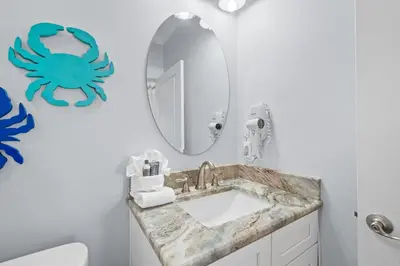 a bathroom with a sink and a mirror at Beach House - Riviera Retreat by Panhandle Getaways in Panama City Beach