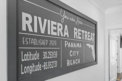 a black and white photo of a sign on a wall at Beach House - Riviera Retreat by Panhandle Getaways in Panama City Beach