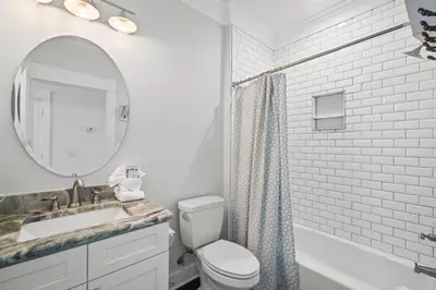 a bathroom with a sink and a toilet and a mirror at Beach House - Riviera Retreat by Panhandle Getaways in Panama City Beach
