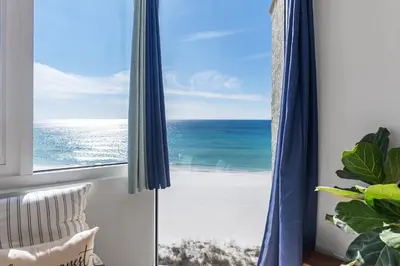 a room with a window with a view of the ocean at Seaview Studio at Top of the Gulf #823 by Nautical Properties in Panama City Beach
