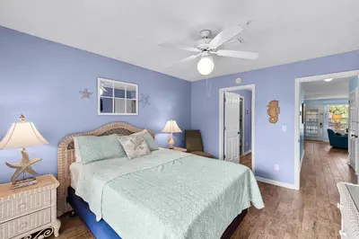 a bedroom with a bed and a ceiling fan at Peachtree Place Ii C202 in Panama City Beach
