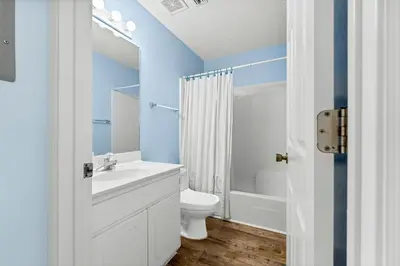 a bathroom with a white toilet and a sink at Peachtree Place Ii C202 in Panama City Beach