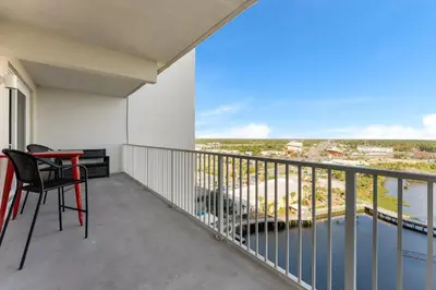 a balcony with a table and chairs and a view at Laketown Wharf #1232 in Panama City Beach