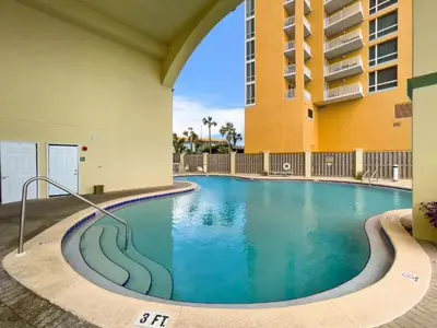 a swimming pool in the courtyard of a building at Celadon #0808 in Panama City Beach