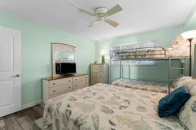 a bedroom with two bunk beds and a ceiling fan at Regency Towers #0307 in Panama City Beach