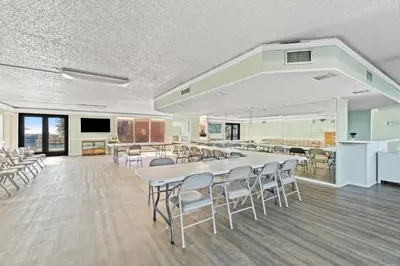 a conference room with a large table and chairs at Regency Towers #0307 in Panama City Beach