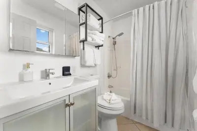 a white bathroom with a sink and a toilet at Sunset Haus in Panama City Beach