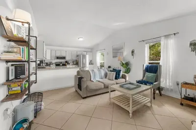 a living room with a couch and a table at Sunset Haus in Panama City Beach