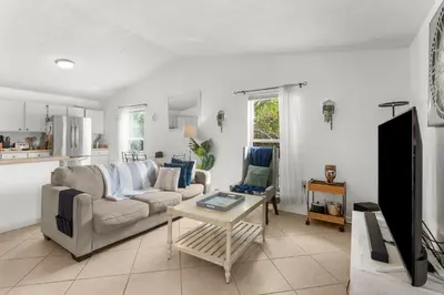 a living room with a couch and a table at Sunset Haus in Panama City Beach