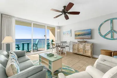 a living room with a couch and a ceiling fan at Majestic Beach Towers #2-1203 in Panama City Beach