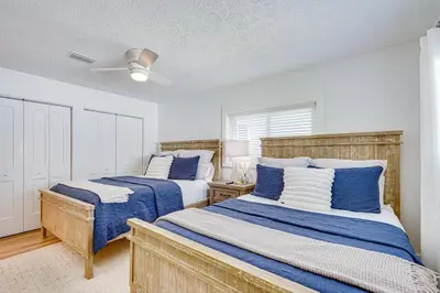 a bedroom with two beds and a ceiling fan at Walk to Beach Chic PCB Getaway with Yard in Panama City Beach