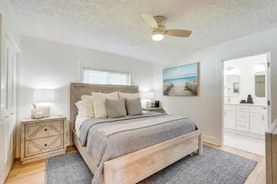a bedroom with a bed and a ceiling fan at Walk to Beach Chic PCB Getaway with Yard in Panama City Beach