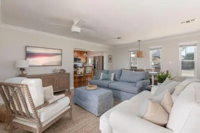 a living room with a white couch and chairs at Shells Family Beach House Coastal Retreat with Private Pool Golf Cart & Steps to the Beach in Panama City Beach