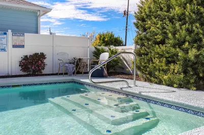 a swimming pool in a yard with a pool at Shells Family Beach House Coastal Retreat with Private Pool Golf Cart & Steps to the Beach in Panama City Beach