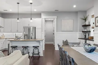 a kitchen and living room with a table and chairs at Seagrove Sunshine in Seagrove Beach